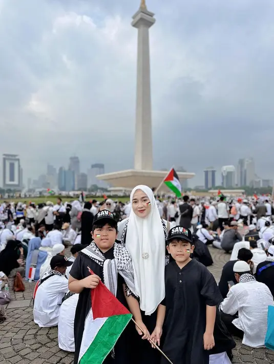 Terlihat Ririe Fairus juga membawa anaknya dalam acara tersebut. Mantan istri Ayus Sabyan itu kompak dengan dua anak laki-lakinya mengenakan outfit hitam. Sedangkan pipi mereka ditempel bendera Palestina. [Instagram/ririe_fairus]