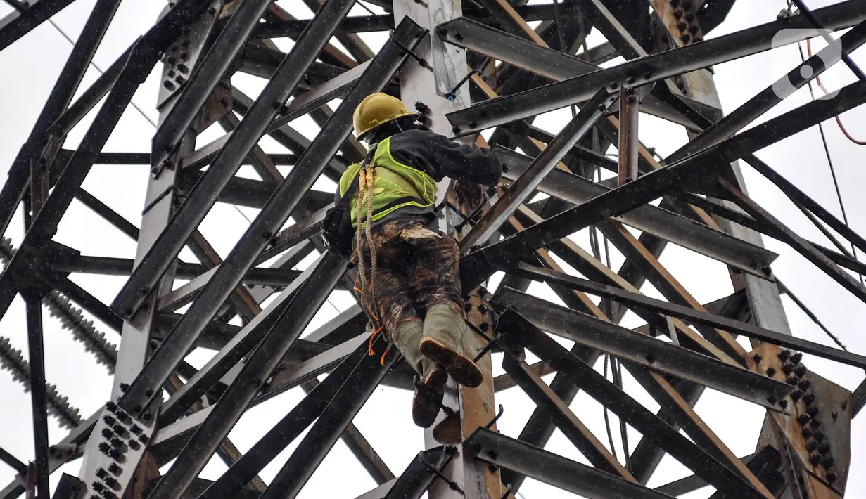 Pekerja menyelesaikan perbaikan menara saluran udara tegangan ekstra tinggi (SUTET) di Jakarta, Rabu (15/2/2023). Para pekerja yang ditugaskan wajib dilengkapi standar alat keselamatan diri karena profesi ini sangat berisiko, bahkan bertaruh nyawa. (merdeka.com/Iqbal S. Nugroho)