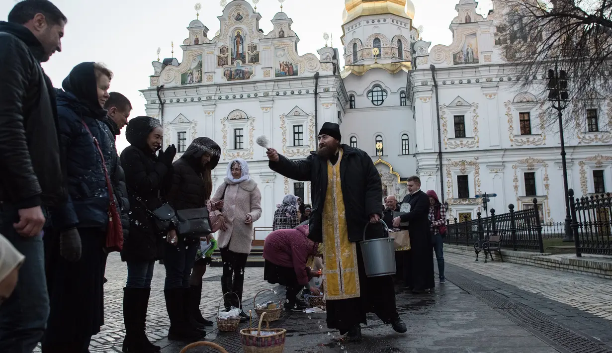 Imam Ortodoks Ukraina memberkati jemaatnya saat perayaan Paskah di gereja Kyiv-Pechersk Lavra di Kiev, Ukraina (8/4). Gereja Ortodoks Timur biasanya merayakan Paskah beberapa minggu setelah perayaan Paskah di gereja Barat. (AP Photo / Evgeniy Maloletka)