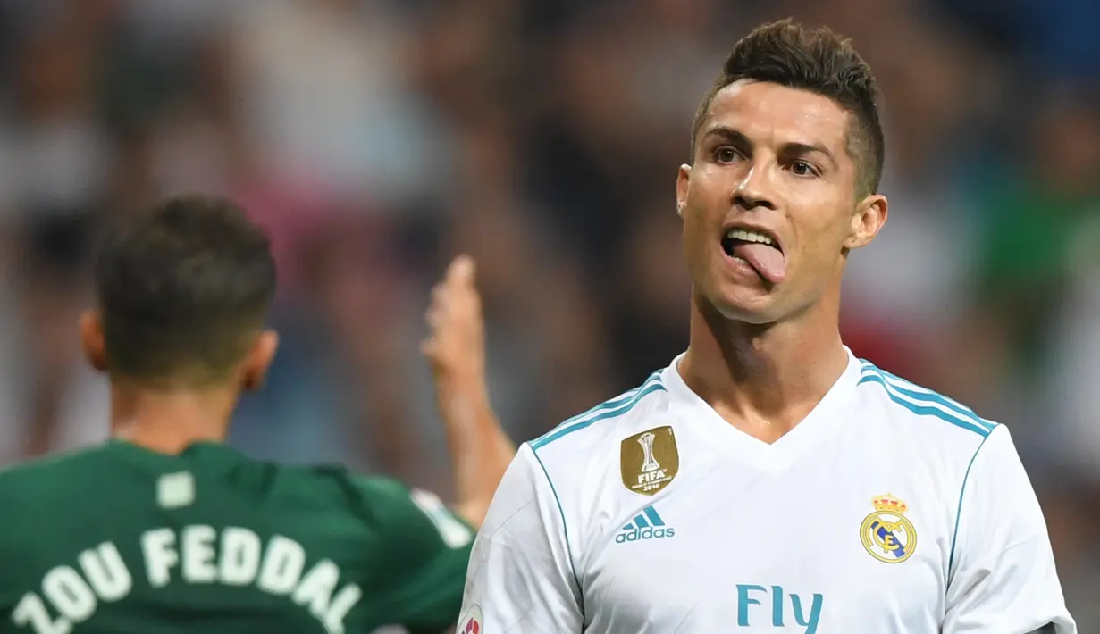 Penyerang Real Madrid, Cristiano Ronaldo menjulurkan lidah saat menjalani laga pekan lima La Liga melawan Real Betis di Santiago Bernabeu, Rabu (20/9). Real Madrid di luar dugaan dipermalukan Real Betis 0-1. (GABRIEL BOUYS/AFP)