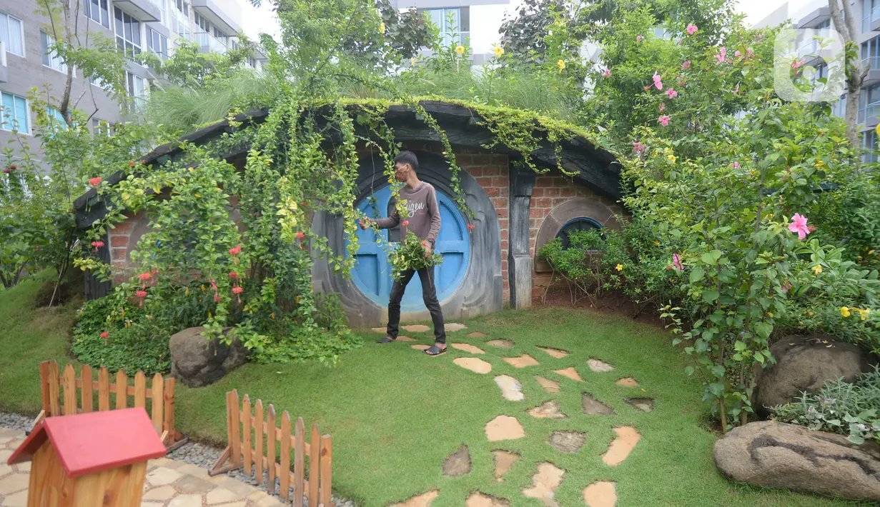 Pekerja merawat tanaman di taman tematik bernuansa rumah hobbit di kawasan hunian vertikal di Serpong, Tangerang, Banten, Kamis (3/12/2020). aman tematik tersebut bertujuan untuk mendukung relasi sosial antar warga serta menciptakan hunian sehat di tengah pandemi COVID-19. (merdeka.com/Dwi Narwoko)