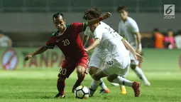 Pemain sayap Timnas Indonesia U-23. Riko Simanjuntak (kiri) berebut bola dengan pemain Korea Selatan U-23 pada laga persahabatan di Stadion Pakansari, Kab Bogor, Sabtu (23/6). Babak pertama Indonesia U-23 tertinggal 0-1. (Liputan6.com/Helmi Fithriansyah)