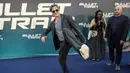 Brad Pitt bercanda dengan kameramen saat tiba pada pemutaran perdana film Bullet Train di Paris, Prancis, 18 Juli 2022. Brad Pitt mengenakan sepasang sepatu olahraga putih saat dia mengangkat kakinya ke arah fotografer sambil berjalan di karpet biru. (AP Photo/Lewis Joly)