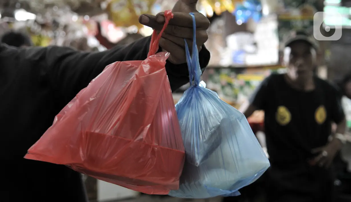 Warga menunjukkan barang belanjaan yang dibawa menggunakan kantong plastik sekali pakai di Pasar Tebet Barat, Jakarta, Kamis (6/2/2020). Masih banyak pedagang maupun pembeli yang menggunakan kantung plastik sebagai tempat bawaan membawa belanjaan. (merdeka.com/Iqbal S Nugroho)