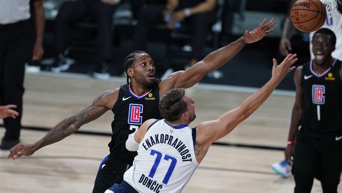 Kawhi Leonard mencoba mengadang Luka Doncic di play-off NBA (AP)