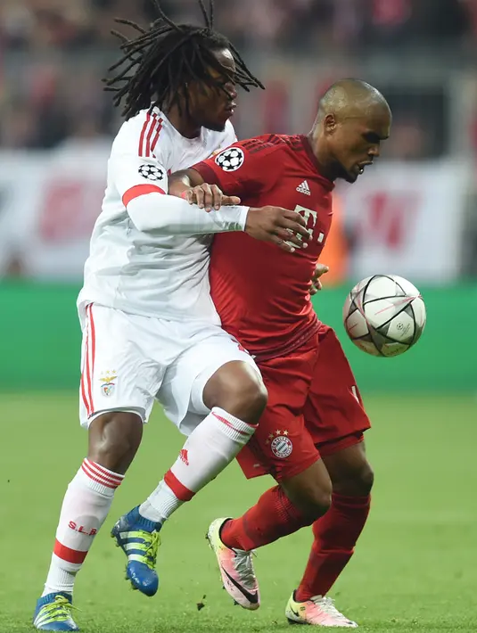 Gelandang Muenchen, Douglas Costa (kanan) berusaha mengontrol bola dari kawalan gelandang Benfica, Renato Sanches pada leg pertama liga champions di Allianz Arena, Jerman, (6/4). Muenchen menang tipis atas Benfica dengan skor 1-0. (AFP/Christof stache)
