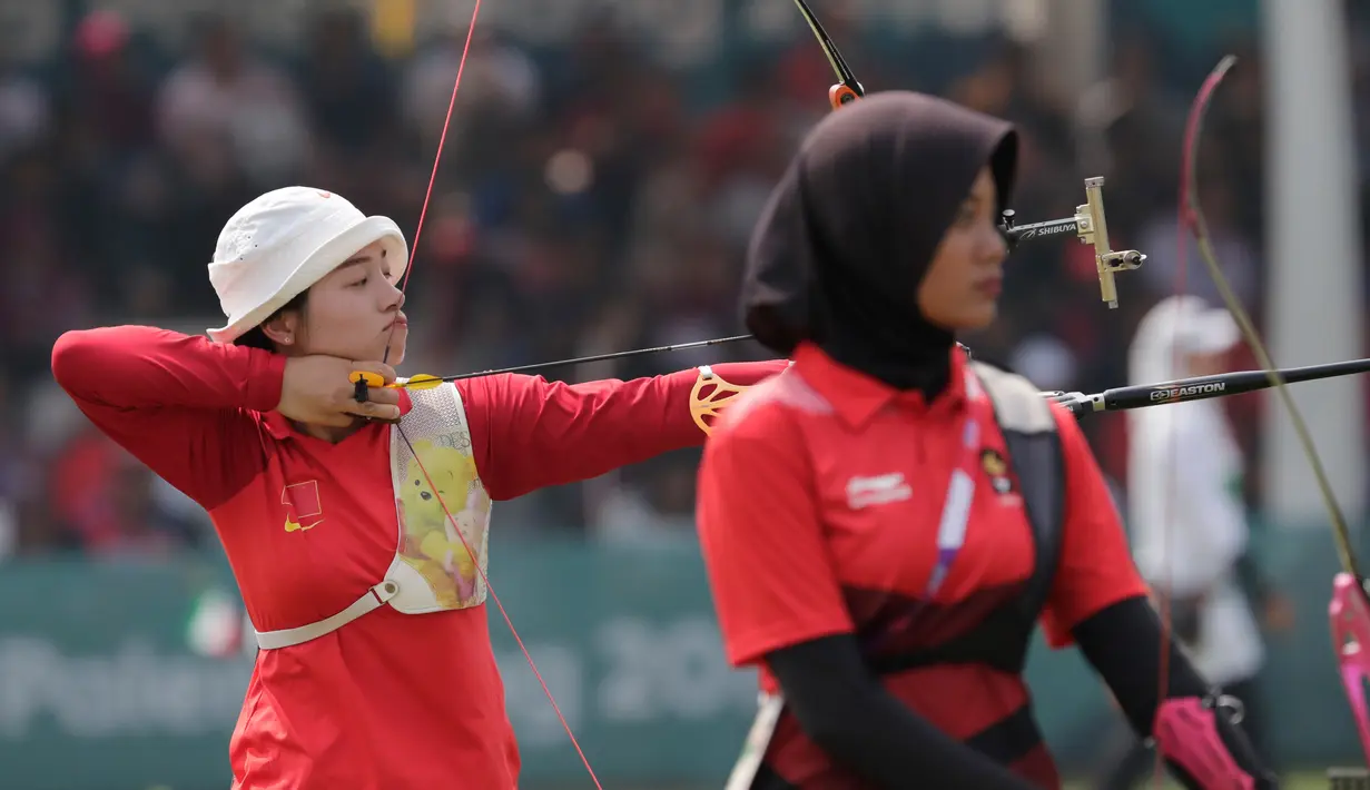 Pemanah putri Indonesia, Diananda Choirunisa (kanan) saat bertanding melawan Zhang Xinyan (kiri) asal China di nomor recurve women individual Asian Games 2018 di Jakarta, Selasa (28/8). Diananda menyabet medali perak. (AP Photo/Lee Jin-man)