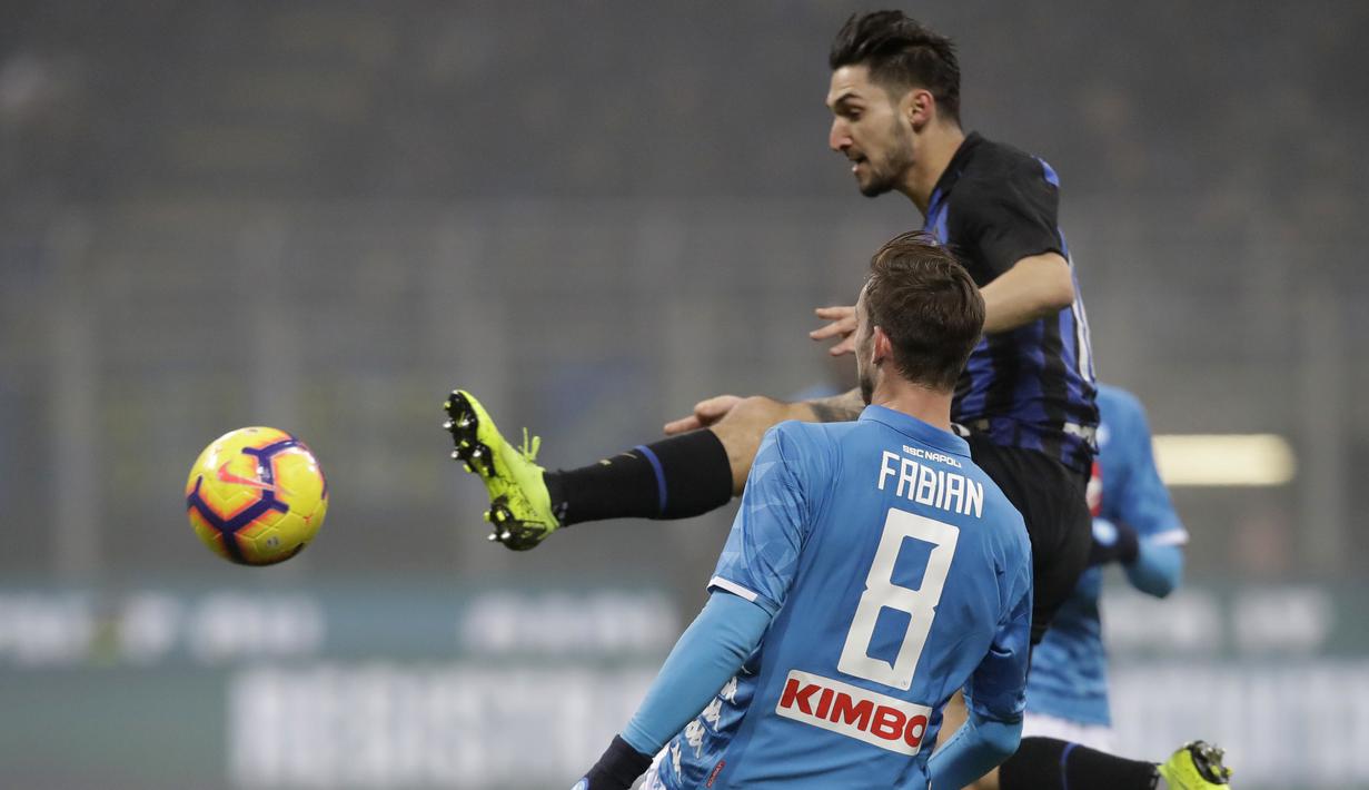 Gelandang Inter Milan, Matteo Politano, berebut bola dengan pemain Napoli, Fabian Ruiz, pada laga Serie A di Stadion San Siro, Rabu (26/12). Inter Milan menang 1-0 atas Napoli. (AP/Luca Bruno)