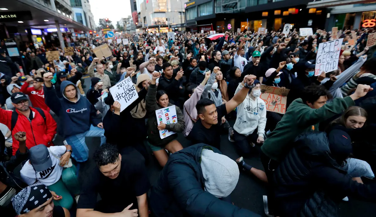 Demonstran memegang plakat saat memprotes kematian George Floyd di pusat Auckland, Selandia Baru, Senin (1/6/2020). Kematian pria kulit hitam George Floyd saat ditangkap oleh polisi Amerika Serikat memicu kemarahan di sejumlah negara. (Dean Purcell/New Zealand Herald via AP)