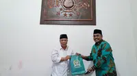 Wakil Ketua MPR Jazilul Fawaid menyerahkan cinderamata berupa buku kepada sesepuh NU DKI KH Muhyiddin Ishaq saat bersilaturahim di  Jakarta Selatan, Jumat (5/3/2021). (Istimewa)