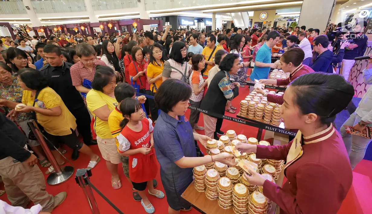 Suasana antrian pembagian kue bulan pada perayaan Festival Musim Gugur di Pluit Village, Jakarta, Sabtu (22/9). Festival Musim Gugur atau Festival Kue Bulan identik dengan pembagian kue bulan sebagai lambang kesejahteraan. (Liputan6.com/Herman Zakharia)