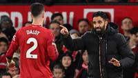 Pelatih kepala Manchester United asal Portugal, Ruben Amorim (kanan), berbicara dengan bek Manchester United asal Portugal bernomor punggung 02, Diogo Dalot (kiri), selama pertandingan Liga Inggris antara Manchester United dan Bournemouth di Old Trafford, Manchester, barat laut Inggris, Sabtu (27-12-2025) dini hari WIB. (PETER POWELL/AFP)