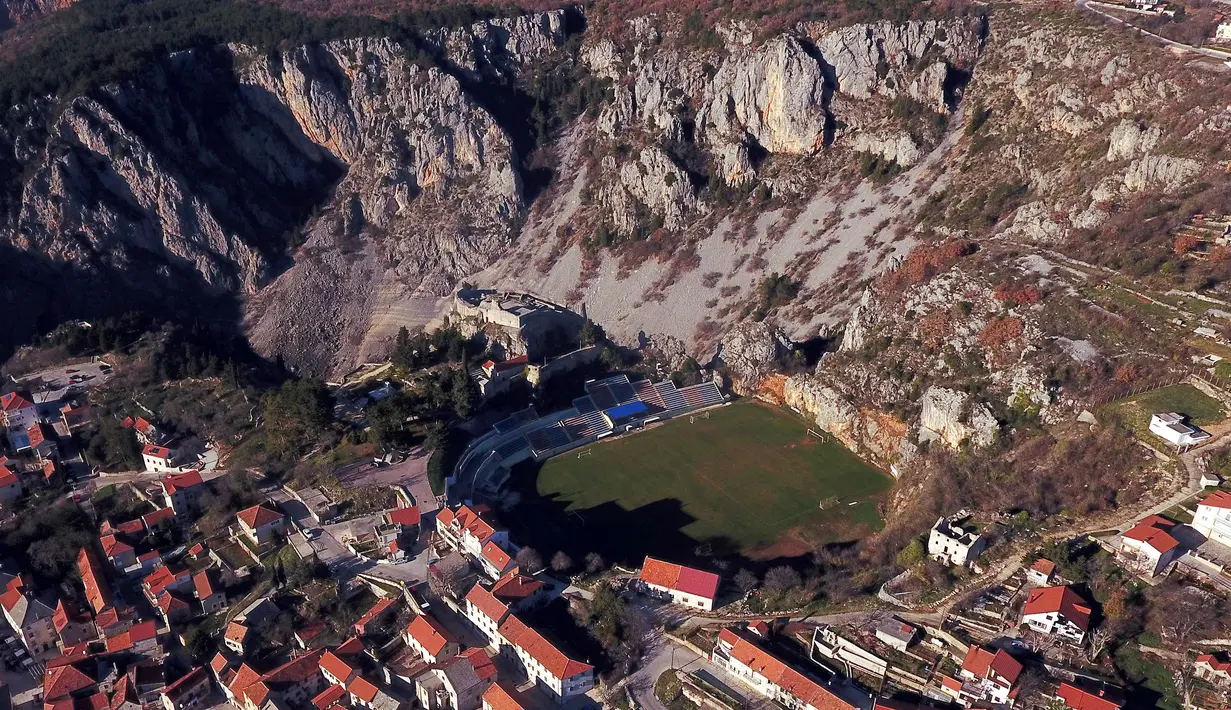 <p>Pemandangan lapangan sepak bola Gospin Dolac yang berada di Kota Imotski, Dalmatia, Korasia, 27 Desember 2017. Lapangan dengan pemandangan pegunungan yang menawan ini digunakan oleh klub sepak bola Kroasia, NK Imotski. (Branimir BOBAN/AFP)</p>