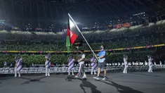 Seorang relawan membawa bendera nasional Afghanistan dalam defile upacara pembukaan Paralimpiade Tokyo 2020 di Tokyo, Selasa (24/8/2021). Bendera Afghanistan dikibarkan tanpa kehadiran satu pun atletnya menyusul kondisi negaranya pasca dikuasai oleh Taliban. (Joel Marklund for OIS via AP)