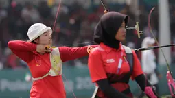 Pemanah putri Indonesia, Diananda Choirunisa (kanan) saat bertanding melawan Zhang Xinyan (kiri) asal China di nomor recurve women individual Asian Games 2018 di Jakarta, Selasa (28/8). Diananda menyabet medali perak. (AP Photo/Lee Jin-man)