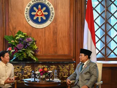 Menteri Pertahanan Republik Indonesia yang juga Presiden terpilih periode 2024-2029, Prabowo Subianto (kanan) berbincang dengan Presiden Filipina Ferdinand Marcos Jr dalam sebuah kunjungan kehormatan di Istana Malacanang, Manila, 20 September 2024. (Jam Sta Rosa/POOL/AFP)