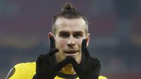 Penyerang Tottenham, Gareth Bale berselebrasi usai mencetak gol ke gawang Wolfsberger AC pada leg pertama babak 32 besar Liga Europa di stadion Puskas Arena, Hongaria, Jumat (19/2/2021).  Kemenangan tandang ini membuat Tottenham menaruh satu kakinya di babak selanjutnya. (AP Photo/Laszlo Balogh)