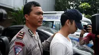 Tersangka kasus kecelakaan maut di Pondok Indah, Christopher Daniel Sjarif dikawal petugas saat hendak meninggalkan Dirlantas Polda Metro dibawa ke tahanan Kejaksaan Negeri Jakarta Selatan, Kamis (16/4/2014). (Liputan6.com/Johan Tallo)