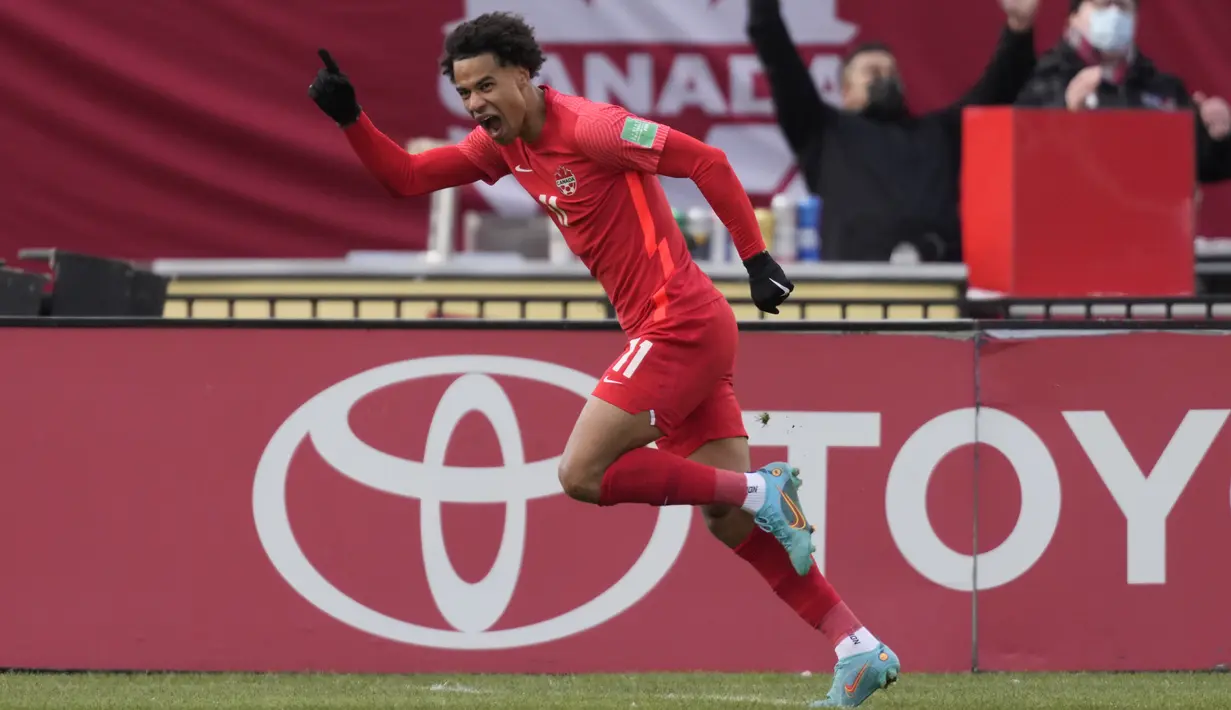 Penyerang Kanada Tajon Buchanan berselebrasi setelah mencetak gol ke gawang Jamaika pada pertandingan Kualifikasi Piala Dunia 2022 Zona CONCACAF di Venue BMO Field, Senin (28/3/2022) dini hari WIB. Kanada lolos ke Piala Dunia 2022 usai melibas Jamaika 4-0. (Nathan Denette/The Canadian Press via AP)