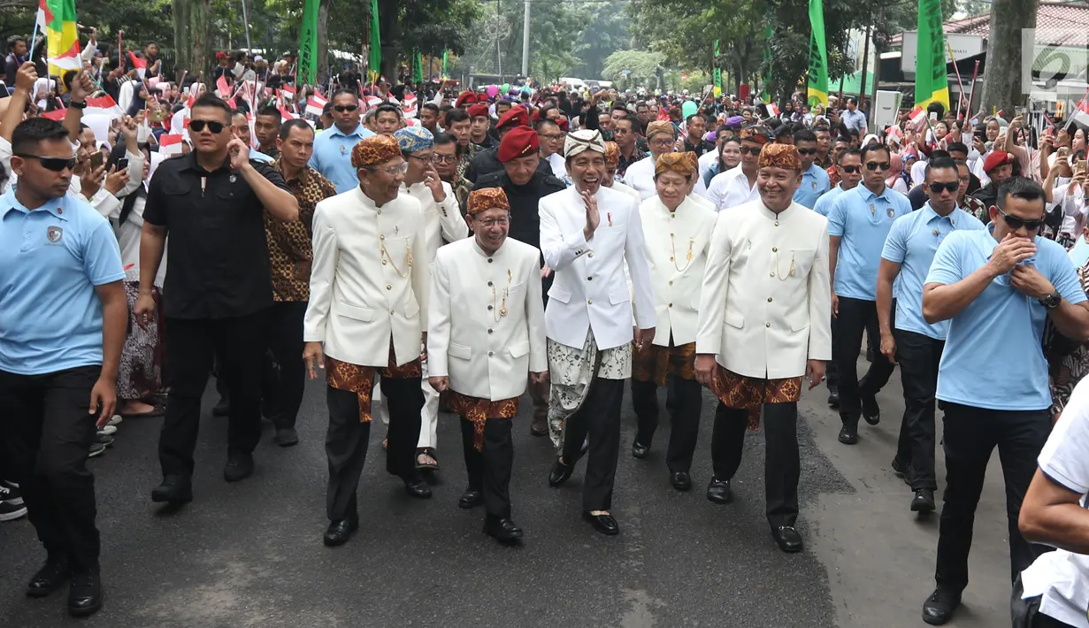 Presiden Joko Widodo atau Jokowi menyapa warga saat mengunjungi kantor Paguyuban Pasundan di kota Bandung,  Jawa Barat, Minggu (11/11). Presiden Jokowi menerima penganugerahan sebagai Pinisepuh dari Paguyuban Pasundan. (Liputan6.com/Angga Yuniar)