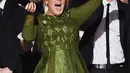 Adele tiba-tiba mematahkan satu piala Grammy miliknya saat ia memberikan sambutan kemenangan di ajang Grammy Awards 2017 di Staples Center, Los Angeles, Minggu (12/2). Adele menyebut setengah dari piala itu adalah hak Beyonce. (AFP PHOTO/ KEVIN WINTER)