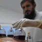 Spesialis melakukan pengobatan hijama atau terapi bekam basah kepada pasien di sebuah klinik di Ajman, Uni Emirat Arab, Kamis (15/8/2019). Hijama berasal dari istilah bahasa Arab yang berarti pelepasan darah kotor. (KARIM SAHIB/AFP)