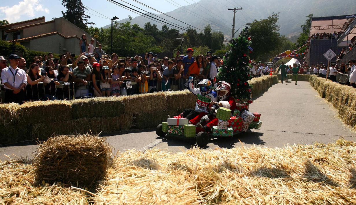 Salah satu peserta mengendarai kendaraannya dalam ajang balap mobil 'Kotak sabun' Red Bull Soapbox di Santiago, Chili, Minggu (27/11). Para pengemudi mengandalkan gaya gravitasi bumi karena kendaraan mereka tidak memiliki mesin. (REUTERS/Jonathan Faus)