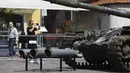 Seorang wanita menggunakan ponselnya mengabadikan tank Rusia yang rusak dan terbakar di Castle Square, di Warsawa, Polandia (27/6/2022). Pihak berwenang Ukraina mengumumkan bahwa ada rencana untuk pameran serupa di ibu kota Eropa lainnya seperti Berlin, Paris, Madrid dan Lisbon. (Foto AP/Michal Dyjuk)