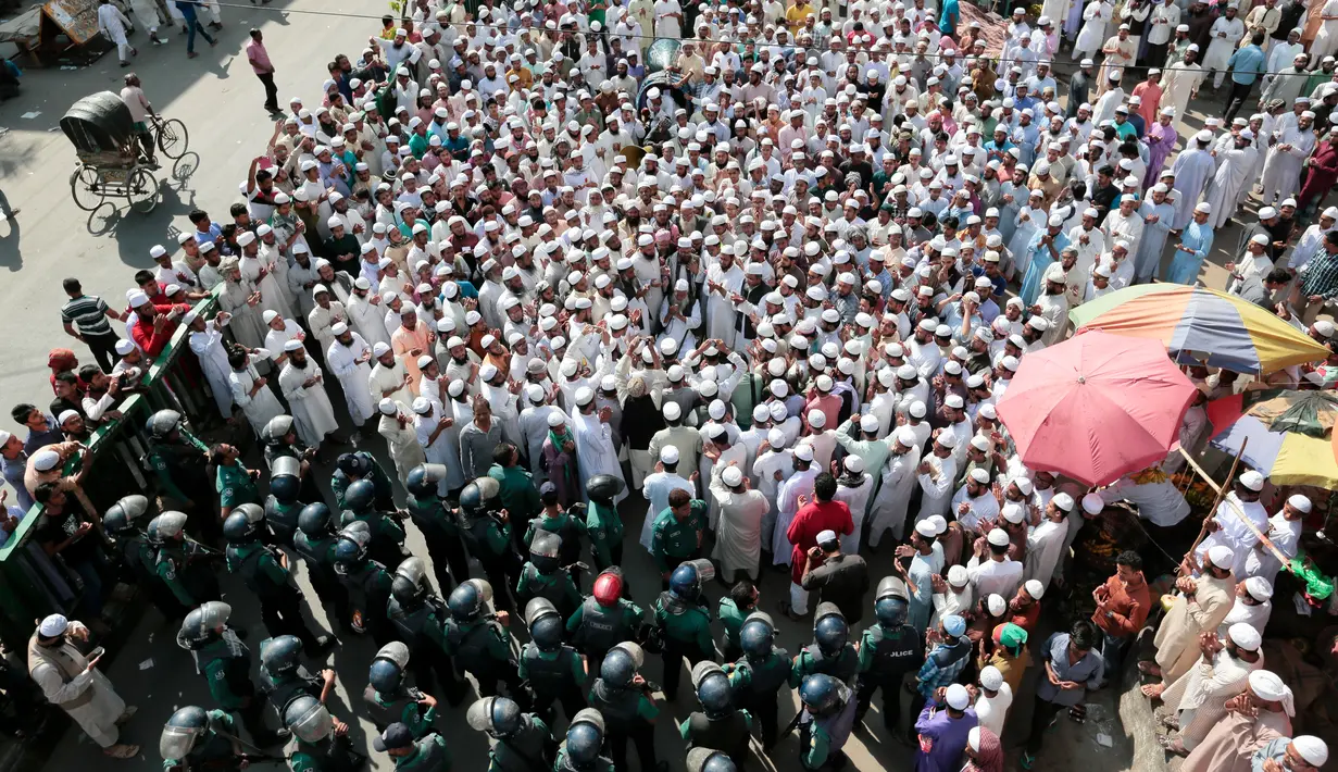 Petugas keamanan setempat menjaga aksi protes yang digelar pendukung dan simpatisan Hefazat-e-Islam di Dhaka, Bangladesh, (24/2). Mereka menuntut menurunkan patung Lady Justice yang berdiri diluar gedung pengadilan. (AP Photo / A.M. Ahad)