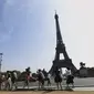 Wisatawan menuju ke Menara Eiffel di Paris, Rabu (31/8/2022). Pariwisata kembali dengan sepenuh hati ke Prancis musim panas ini, mengirimkan pendapatan melebihi tingkat pra-pandemi menurut data pemerintah yang dirilis minggu ini. (AP Photo/Aurelien Morissard)