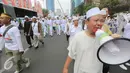 Suasana Parade Tauhid di kawasan Bundaran HI, Jakarta, Minggu (16/8/2015). Parade Tauhid yang diikuti berbagai organisasi massa Islam ini digelar dalam rangka mensyukuri kemerdekaan RI yang ke 70 tahun. (Liputan6.com/Faizal Fanani)