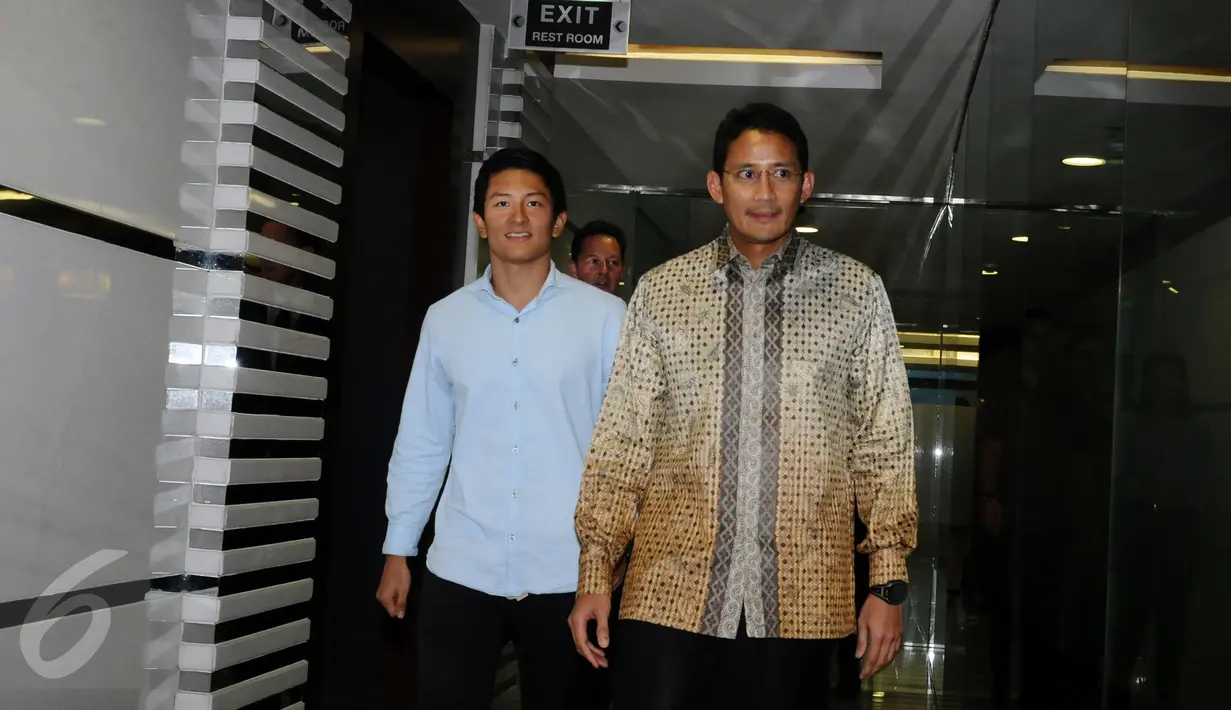 Rio Haryanto (kiri) berjalan bersama Sandiaga Uno usai melakukan pertemuan di gedung Recapital, Jakarta, Selasa (16/2/2016). Sandiaga Uno mengungkapkan kiprah Rio Haryanto di F1 akan memberi keuntungan untuk negara. (Liputan6.com/Helmi Fithriansyah)