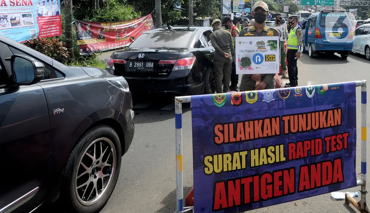 Petugas gabungan Satgas COVID-19 melakukan pemeriksaan dan penyekatan kendaraan di jalur wisata Puncak, Gadog, Bogor, Jawa Barat, Jumat (12/2/2021). Pemeriksaan dan penyekatan sebagai upaya meminimalisir penyebaran COVID-19 saat libur Tahun Baru Imlek 2572 dan akhir pekan. (merdeka.com/Arie Basuki)