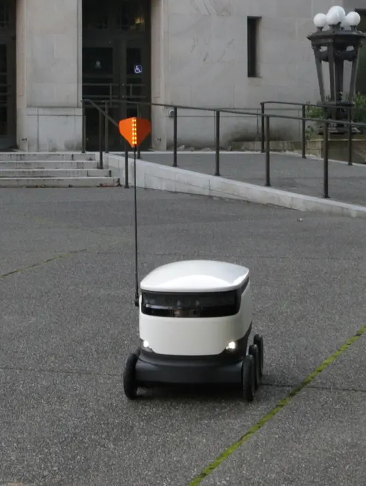 Sebuah robot pengirim barang berkeliling di dekat Washington Capitol di Olympia, Washington, 28 Januari 2019. Anggota parlemen sedang mempertimbangkan undang-undang pengaturan yang akan memungkinkan pengiriman robot di pinggir jalan. (AP/Rachel La Corte)