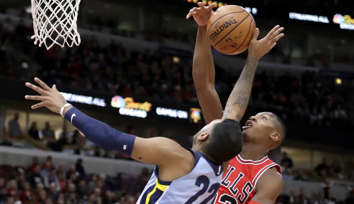 Duel pemain Chicago Bulls, Kris Dunn (kanan) dan pemain Memphis Grizzlies, Xavier Rathan-Mayes pada lanjutan NBA basketball game di United Center, Chicago, (7/3/2018). Chicago Bulls menang 119-110. (AP/Charles Rex Arbogast)