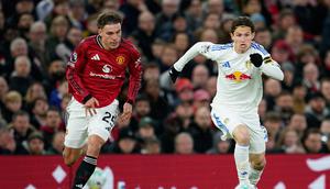 Gelandang Manchester United, Manuel Ugarte mencoba merebut bola dari kaki Brenden Aaronson, Selasa (14/4/2026) (AP Photo/Dave Thompson)