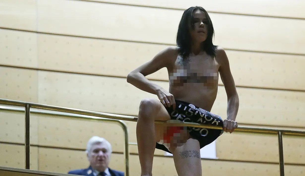 Aktivis Femen saat menghebohkan sidang parlemen di Madrid, Spanyol (9/9/2015). Coretan di tubuh bertuliskan "I decide", menolak rencana pembatasan aborsi untuk wanita di bawah 18 tahun. (REUTERS/Andrea Comas)