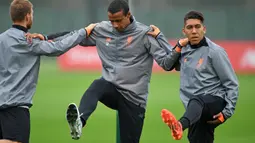 Pemain Liverpool, Roberto Firmino dan Joel Matip, mengangkat kakinya saat mengikuti sesi latihan jelang laga Liga Champions di Melwood, Liverpool, Senin (25/9/2017). Liverpool akan berhadapan dengan Spartak Moskow. (AFP/ Paul Ellis)