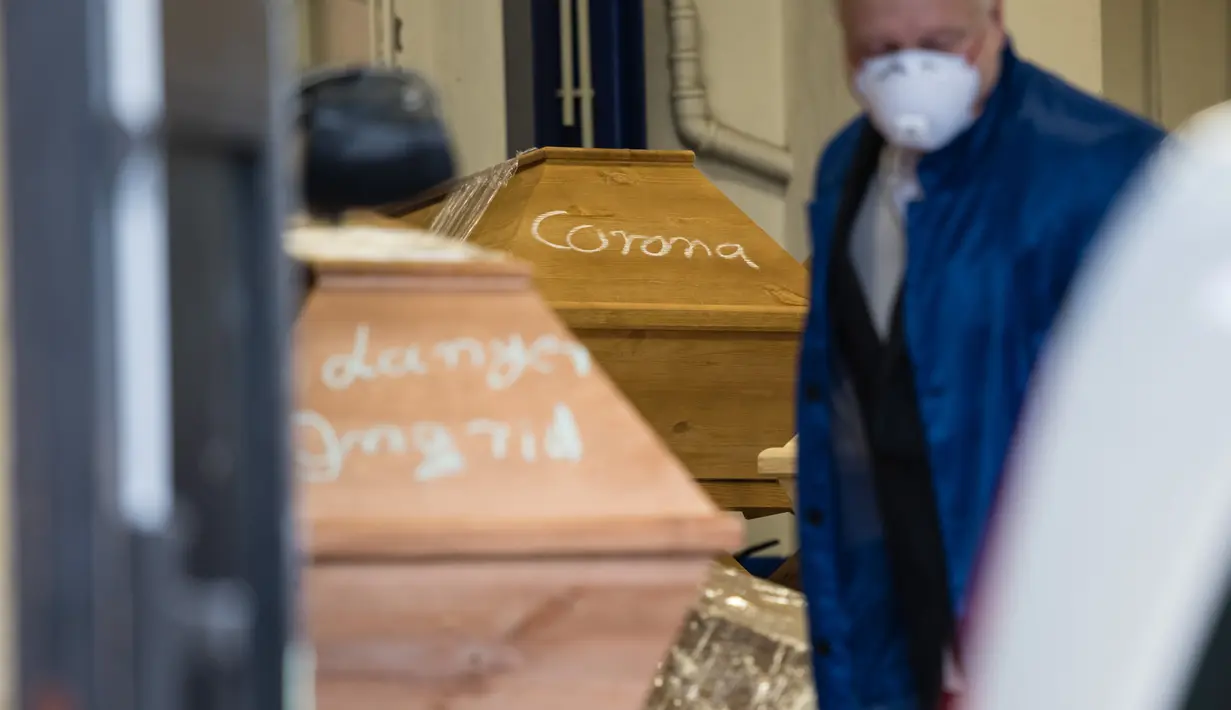 Peti mati dengan tulisan 'Corona' terlihat sebelum dikremasi di krematorium di Meissen, Jerman timur pada 13 Januari 2021. Krematorium sedang melakukan yang terbaik untuk memenuhi permintaan, menyalakan tungku kembar setiap 45 menit dan mengelola 60 kremasi sehari. (JENS SCHLUETER/AFP)