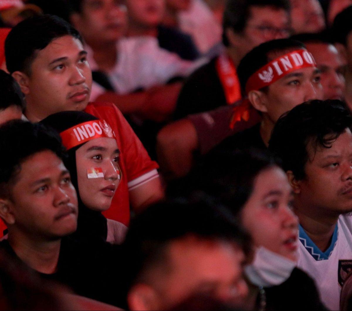 Sejumlah atribut seperti kain ikat kepala bertulisan "Indonesia" hingga stiker bendera Merah Putih yang ditempel di pipi mereka kenakan selama nobar. Foto: Liputan6.com / Herman Zakharia