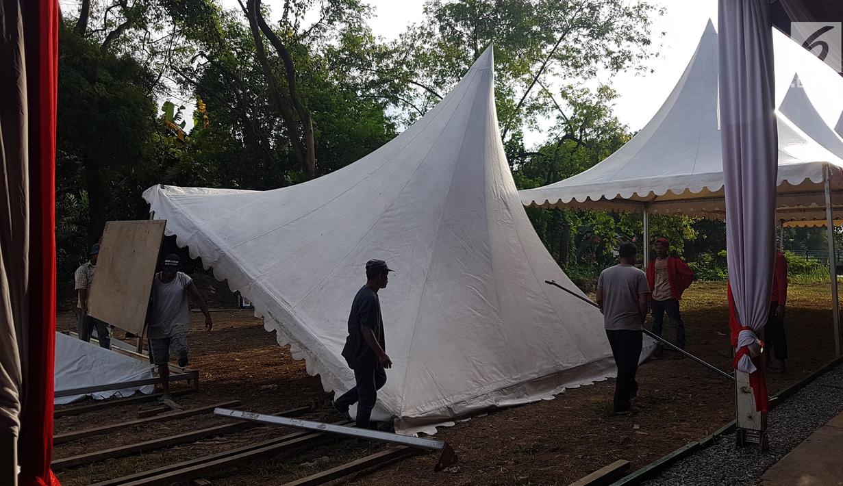 Pekerja mendirikan atap tenda untuk relawan di Jalan Setiabudi, Medan, Senin (20/11). Dari pantauan Liputan6.com, tenda ini berada cukup jauh dari rumah Bobby Nasution yang dijadikan tempat acara. Kira-kira sejauh 1 kilometer. (Liputan6.com/Aditaya Eka)