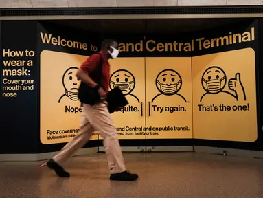 Seseorang dengan masker berjalan di Grand Central Terminal, New York City, Selasa (27/7/2021). Warga Amerika yang divaksinasi penuh harus kembali memakai masker di dalam ruangan di daerah-daerah di mana virus corona dan terutama varian Delta menyebar dengan cepat. (Spencer Platt/Getty Images/AFP)