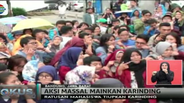 Ratusan mahasiswa di berbagai universitas di Indonesia memainkan alat musik tiup tradisional Jawa Barat karinding di Kota Bandung.