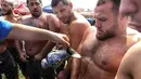 Pegulat Pehlivan disirami minyak sebagai persiapan untuk berkompetisi dalam turnamen Karrestcek Oil Wrestling ke-25 di Ankara (15/9/2019). Kompetisi bernama Kirkpinar merupakan tradisi yang dibanggakan saat Olimpiade modern pertama diadakan di Athena pada 1896. (AFP Photo/Adem Altan)