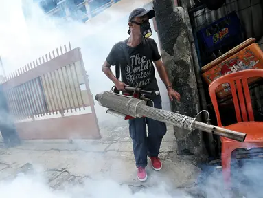 Seorang petugas melakukan pengasapan (fogging) di kelurahan Menteng, Jakarta, Senin (8/2). Pengasapan oleh petugas puskesmas itu dilakukan untuk mencegah wabah penyakit demam berdarah yang kerap muncul pada peralihan musim. (Liputan6.com/Faizal Fanani)
