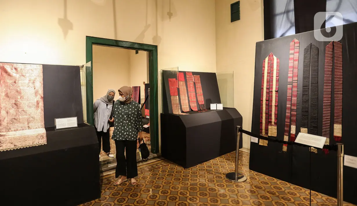 Pengunjung melihat kain tenun di pameran tenun bertajuk "Nuansa Kemilau Wastra Tenun Indonesia" di Museum Tekstil, Jakarta, Rabu (20/7/2022). Pameran dalam rangka memperingati HUT ke - 77 RI ini berlangsung hingga 31 agustus 2022 mendatang dan menampilkan kerajinan tenun dari Sumatera, Sulawesi, dan Timor. (Liputan6.com/Johan Tallo)