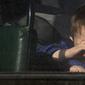 Seorang anak menunggu dalam bus untuk dievakuasi ke Rusia, di Donetsk, wilayah yang dikuasai oleh militan pro-Rusia, Ukraina timur, Sabtu (19/2/2022). Pada Jumat, otoritas separatis di Ukraina timur mengumumkan evakuasi massal perempuan, anak-anak dan orang tua ke Rusia. (AP Photo/Alexei Alexandrov)