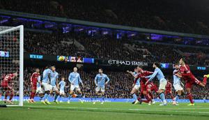Pemain Liverpool, Virgil van Dijk, mencetak gol melalui tandukan kepalanya ke gawang Manchester City pada lanjutan Liga Inggris Etihad Stadium, Minggu (09/1, 1/2025) malam WIB. (AFP/Darren Staples)