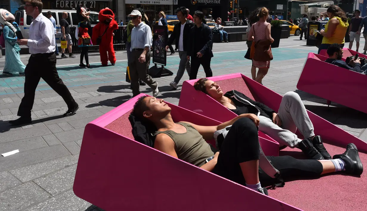 Sejumlah orang menerima tantangan untuk berjemur di sebuah tempat yang telah disediakan di Times Square, New York, AS, Selasa (2/5). (AFP PHOTO / TIMOTHY A. CLARY)