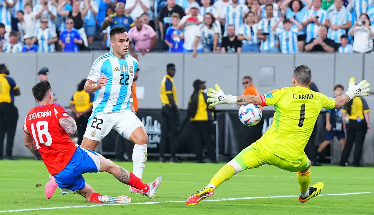 Pemain Argentina, Lautaro Martinez (tengah) berusaha mencetak gol digagalkan kiper Chili, Caludio Bravo pada laga Grup A Copa America 2024 di MetLife Stadium, East Rutherford, New Jersey, Rabu (26/06/2024) WIB. (AFP/Mitchell Leff)